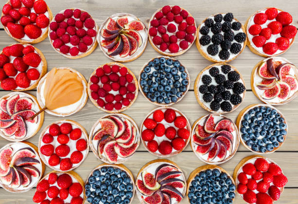 istock Fruit and Berry tarts dessert assorted top view background 828480718