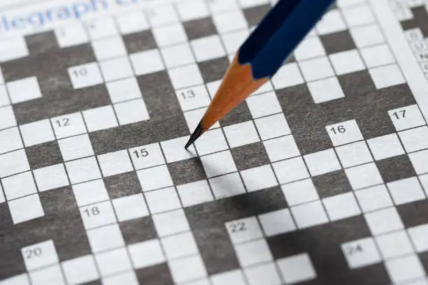 Photo of Crossword Puzzle and Pencil