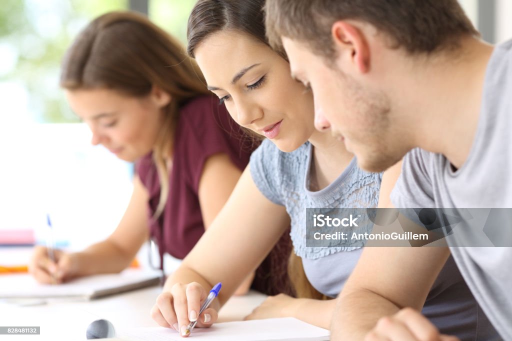 Help A Classmate Student Helping To A Classmate At Classroom Stock Photo - Download ...