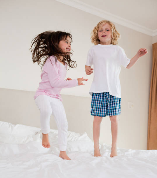 istock Portrait of siblings jumping 828481950