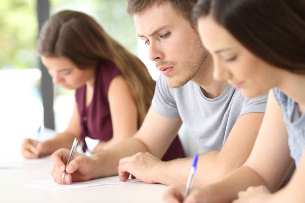 istock Student copying an exam of a classmate 828482060