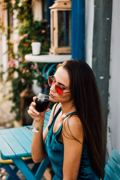 istock Beautiful girl sits in a cafe and drinks wine 828482194