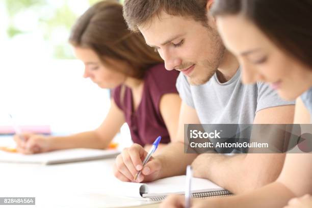 Close Up Of Students Taking Notes At Classroom Stock Photo - Download Image Now - Adolescence, Adult Student, Handwriting