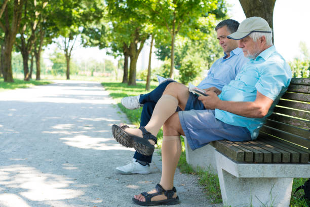 istock Two men reading while sitting on bench on The Trail of Remembrance and Comradeship in Ljubljana, Slovenia 828484916