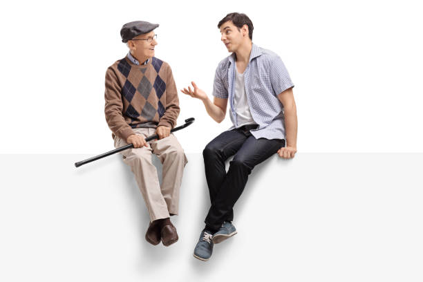 Senior and a young man sitting on a panel and talking