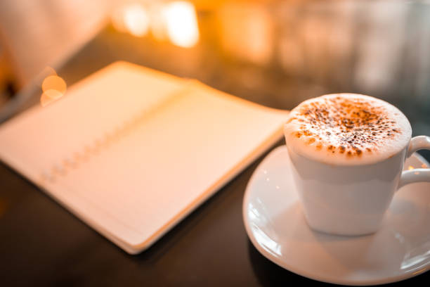 istock Cappuccino coffee and notebook on table in the morning 828489514