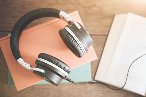 audio book concept with rustic wooden table background