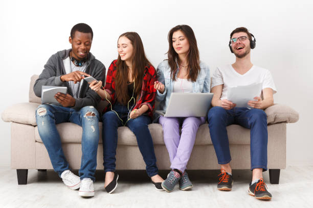 istock Young diverse people listen to music with gadgets 828496860