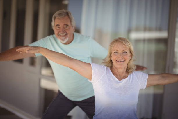istock Smiling senior couple performing stretching exercise 828497526