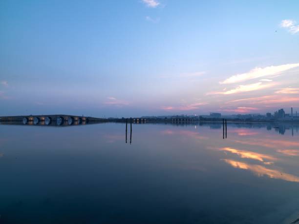 istock stone old bridge on lake with long exposure shot 828499222