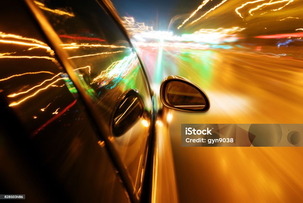 Night, high-speed car A car driving on a motorway at high speeds, overtaking other cars Car Pooling Stock Photo