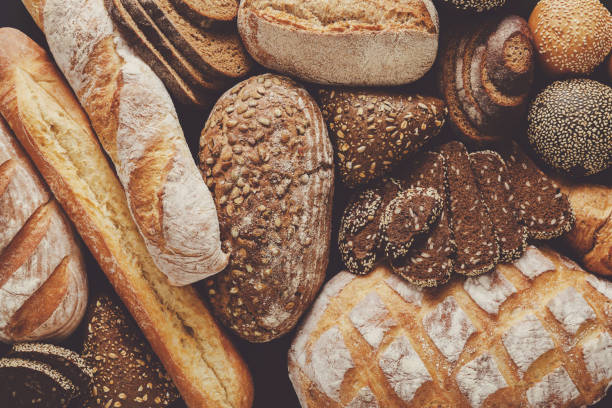 istock Bread background, top view of white, black and rye loaves 828510242