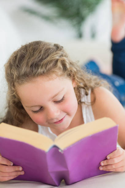 istock Girl resting on the sofa with book 828510318