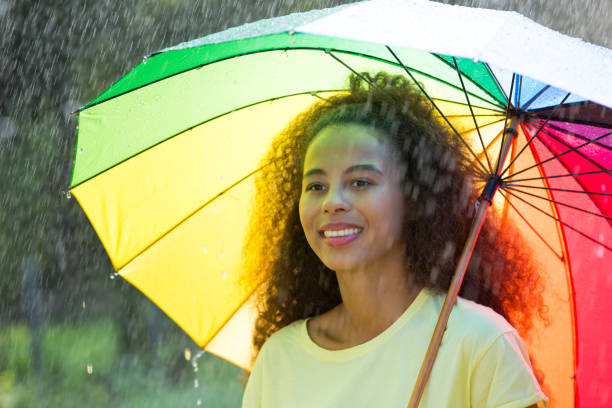 istock Afro american woman with umbrella 828510590