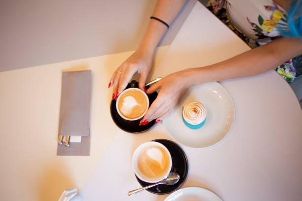 istock girl on a date in cafe, overhead view, coffee for two 828514024