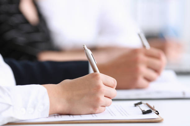 istock Group of people hold silver pen ready to make note 828514746