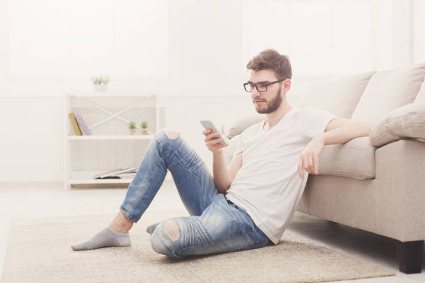istock Young man at home messaging online 828515268