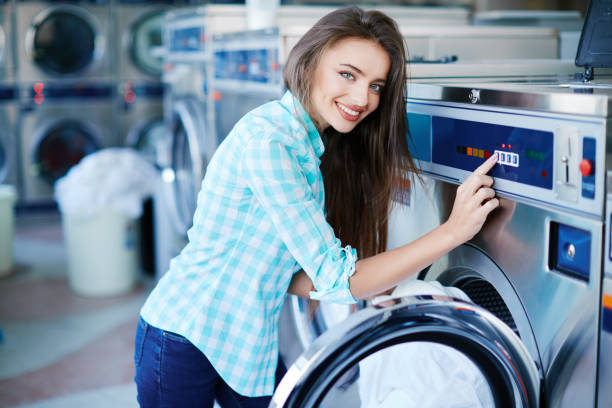 istock Woman  near washing machine 828516406