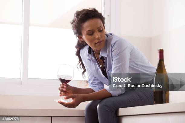 Woman Relaxing After Work By Drinking Wine In The Kitchen Stock Photo - Download Image Now