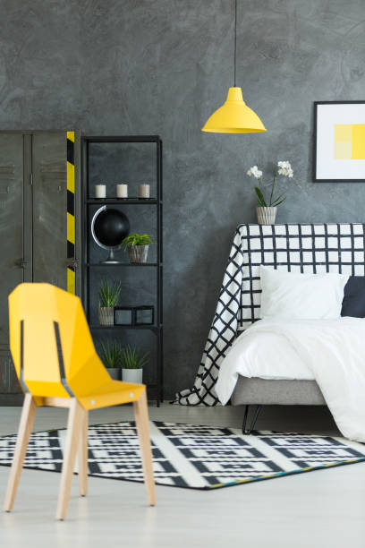 istock Creative dark bedroom with yellow lamp 828522102