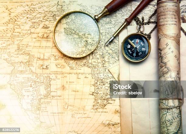 An Brass Compass On A Old Map Background Stock Photo - Download Image Now - Old, Table, World Map