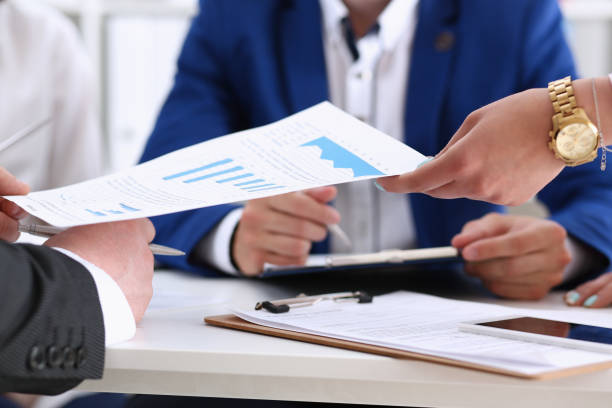 istock Group of people discuss financial results at workplace 828523798