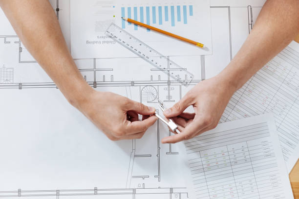istock Flat lay photo of male hands creating engineering drawing 828523820