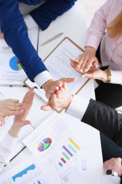 istock Group of people in suits crossed hands in pile 828523984