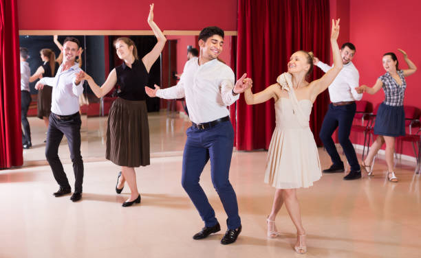 Group people dancing lindy hop in pairs