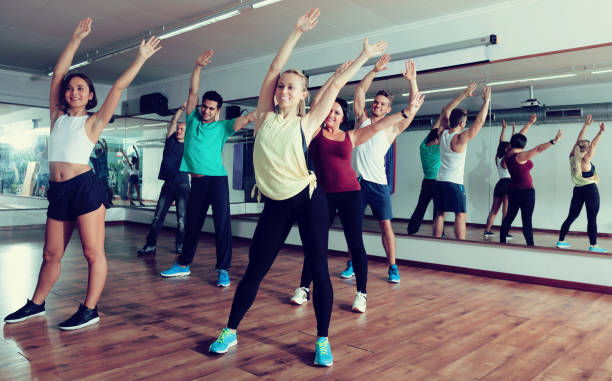 istock Positive people exercising zumba elements together 828524152