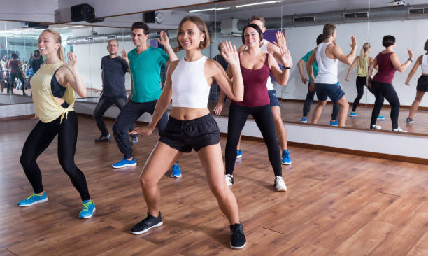 Young happy people dancing zumba elements Young happy people dancing zumba elements in dancing class curtseying stock pictures, royalty-free photos & images