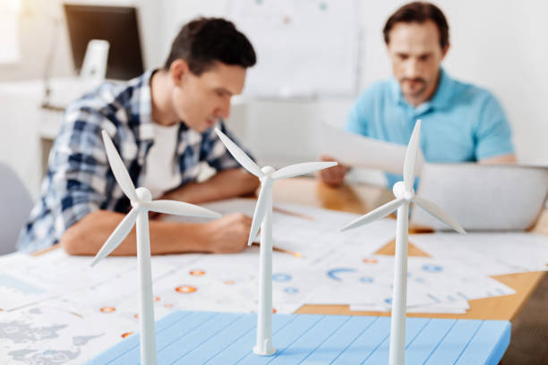 istock Busy young men studying data on the printouts 828524312
