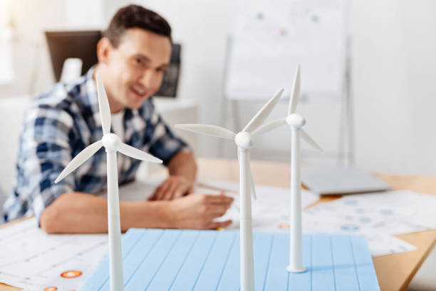 istock Smiling man copying details of wind turbine construction 828526450