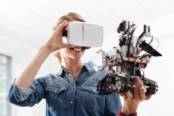 istock Cheerful woman enjoying virtual reality indoors 828527270