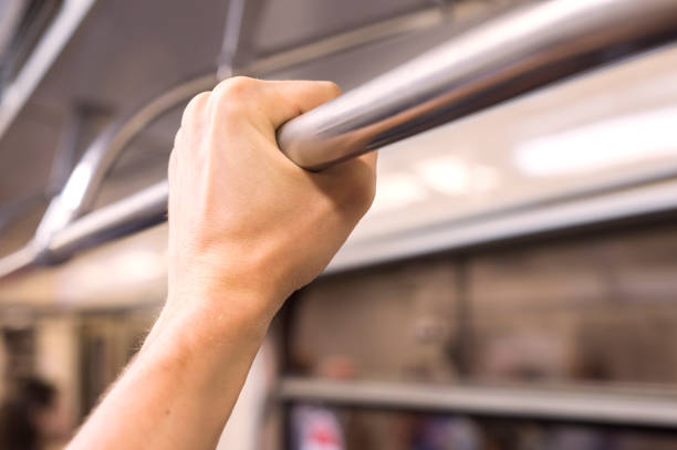istock A man's hand holds on to the rail in the subway 828530414