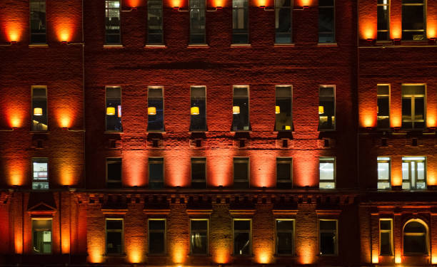 istock Facade of office building in the evening with illuminated windows 828530508