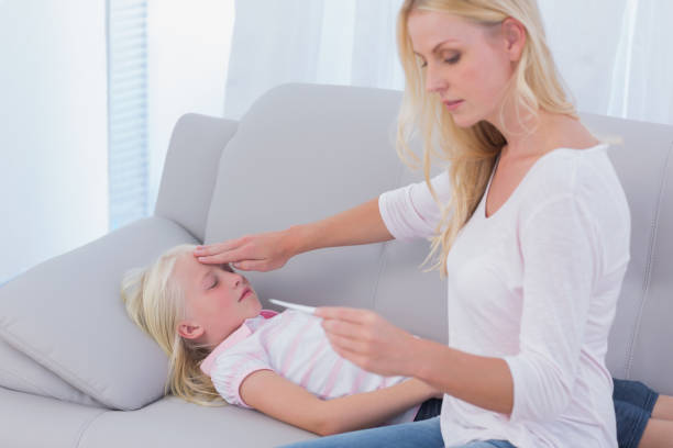 istock Mother taking care of her sick daughter 828544810