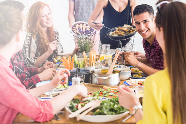 istock Happy people cook and eating together 828545752