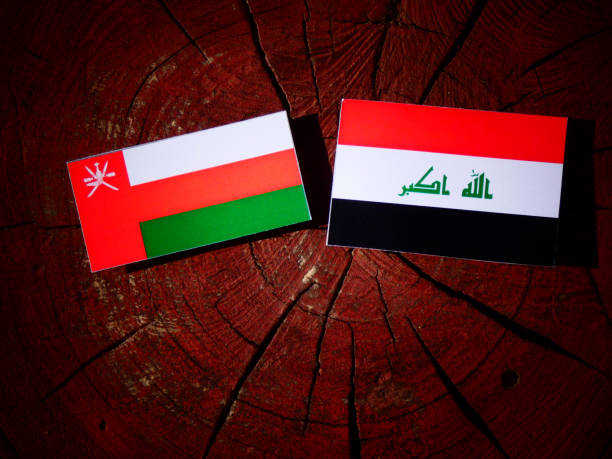 Omani flag with Iraqi flag on a tree stump isolated Omani flag with Iraqi flag on a tree stump isolated iraqi flag stock pictures, royalty-free photos & images