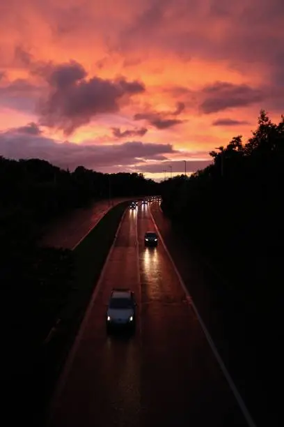 Photo of Headlights on Highway at Sunset