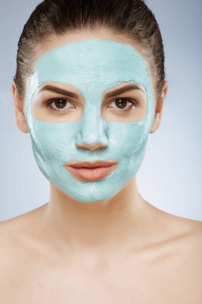 istock Pretty girl doing cosmetic face mask 828554030