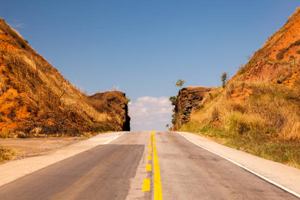 istock Road passing through narrow cutted rock with blue sky 828561494