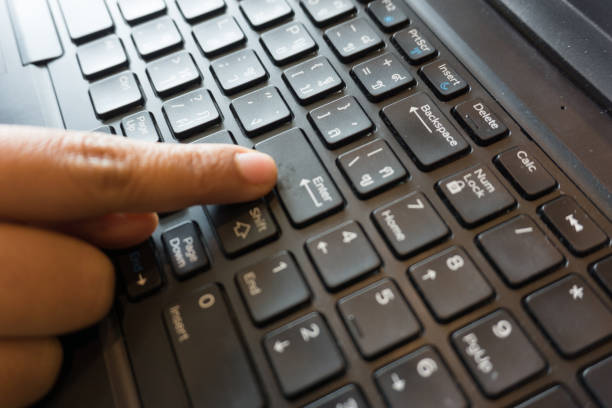 istock close up women finger point or click on enter button on the keyboard 828563008