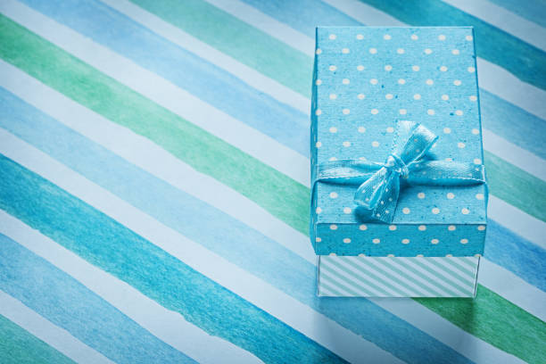 istock Packed gift box on blue striped table cloth holidays concept 828563934