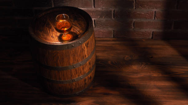 istock Glass of cognac with barrel on wooden table 828569672
