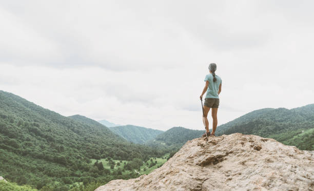 istock Female explorer walking in the mountains. 828570864