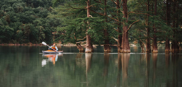 istock Male explorer kayaking on lake Sukko. 828574188