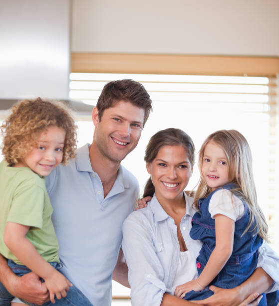 istock Smiling family standing up 828575616
