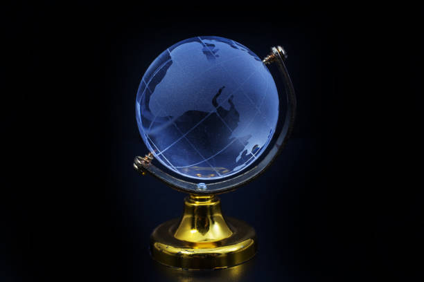 istock Glass globe model gold stand on black table background 828575746