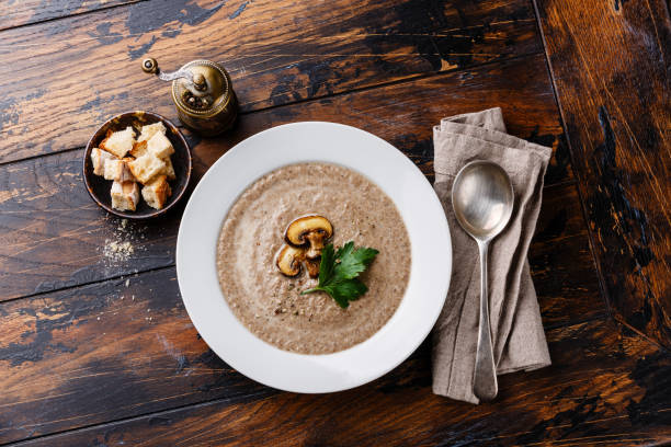 Mushroom soup with brown champignon Mushroom soup with brown champignon on wooden table cream soup stock pictures, royalty-free photos & images